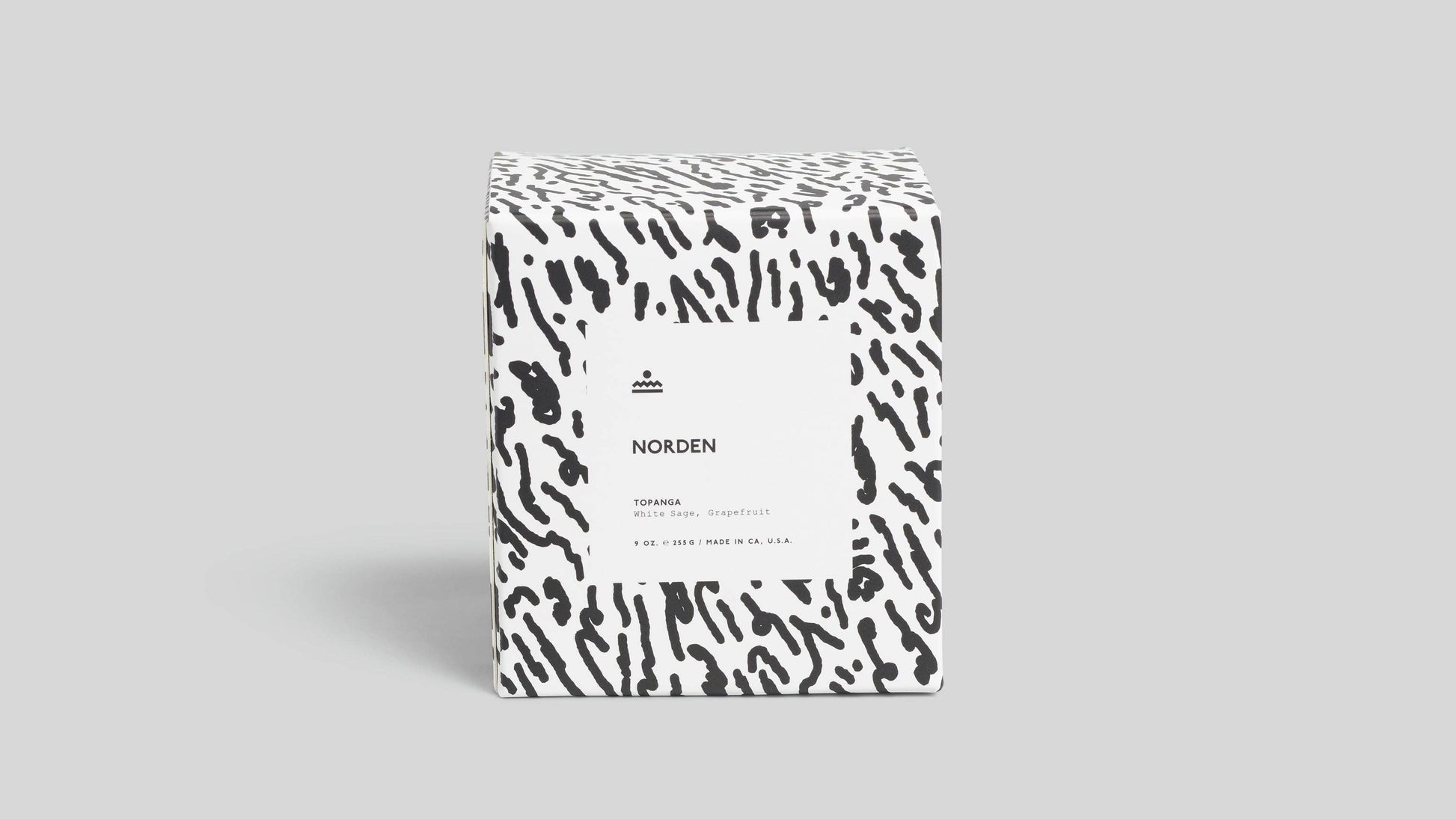 Product packaging with a black and white pattern on a gray background