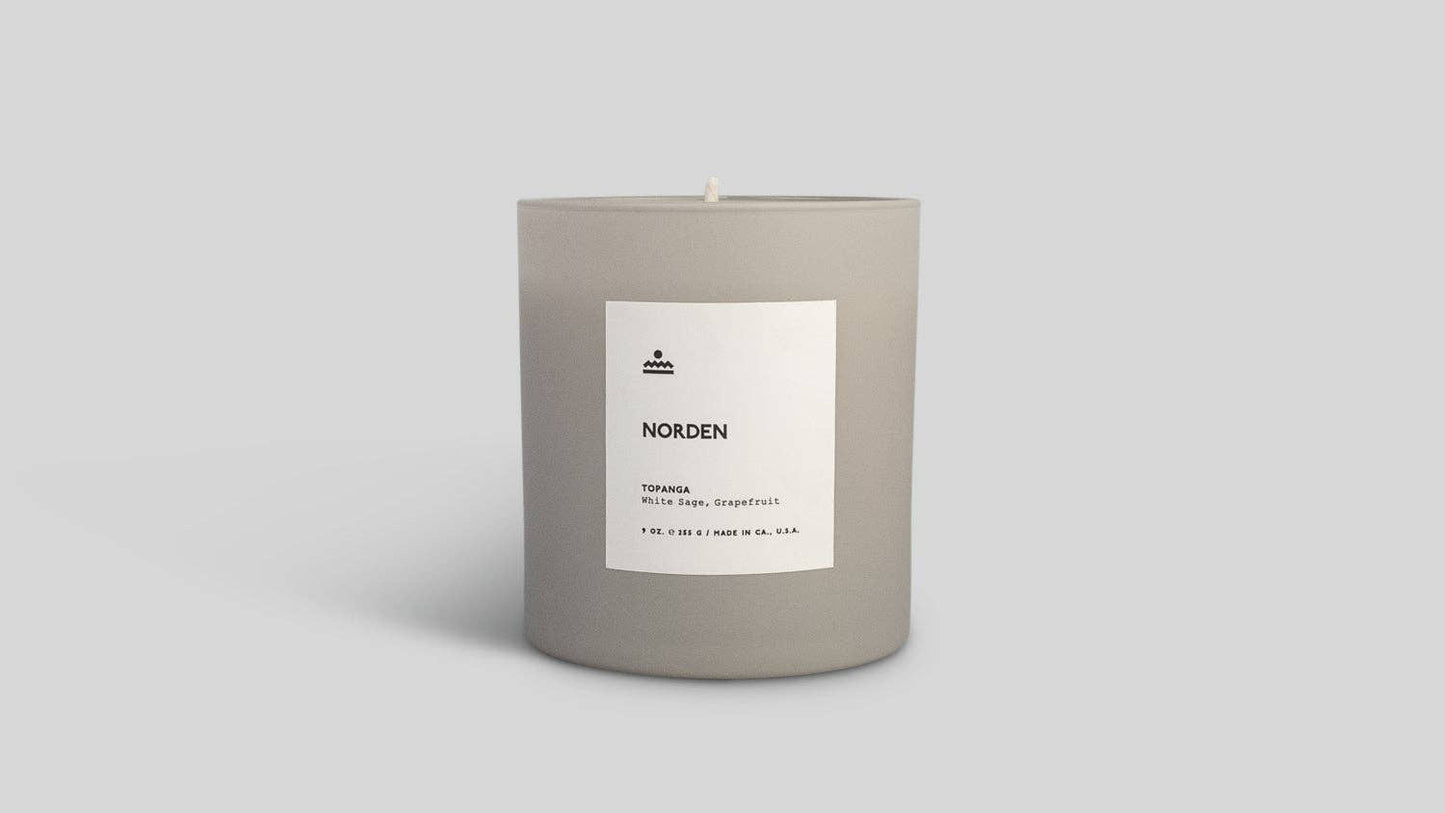 Candle with a label on a light gray background