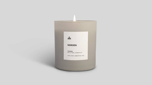 Candle with a label on a gray background