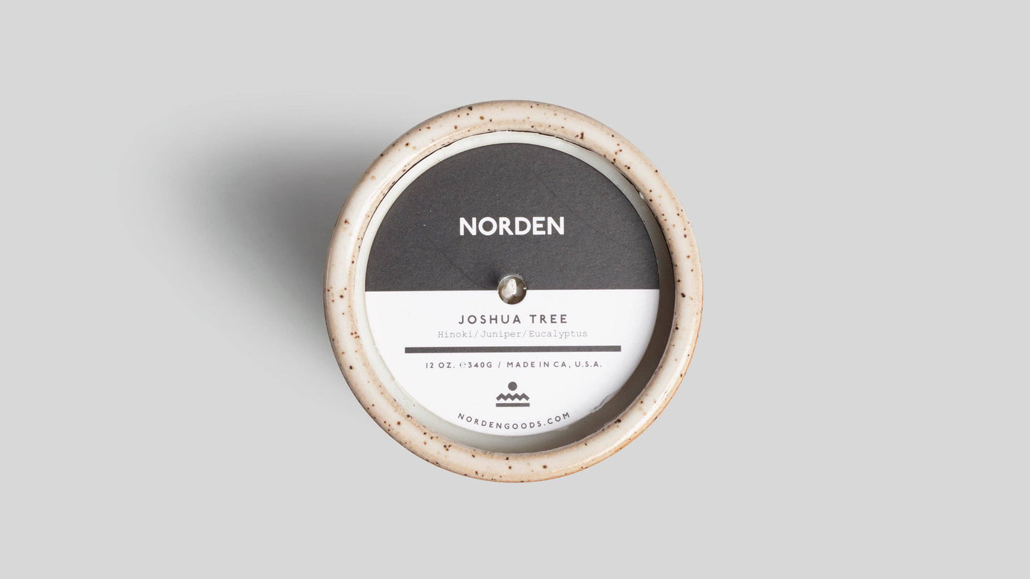 Round product packaging with 'Norden' branding on a gray background