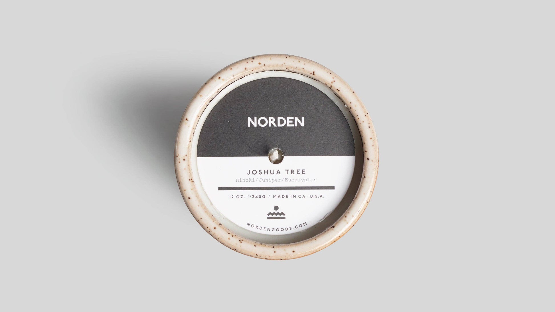 Round product packaging with 'Norden' branding on a gray background