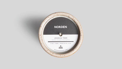 Round product packaging with 'Norden' branding on a gray background